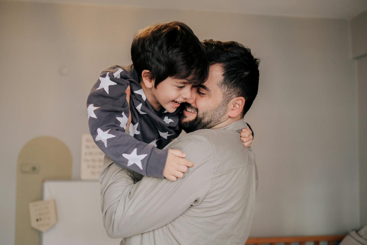 Father hugging his smiling young son, representing BioBru's mission to support families affected by autism